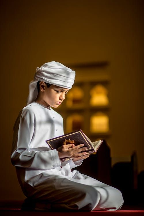 Young student reverently reciting the Holy Qur'an in a 1-on-1 learning session